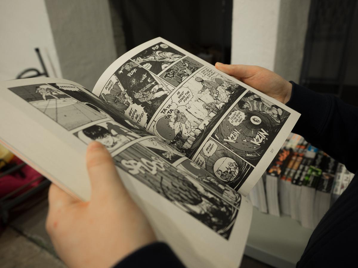 Image of someone holding a manga book with care